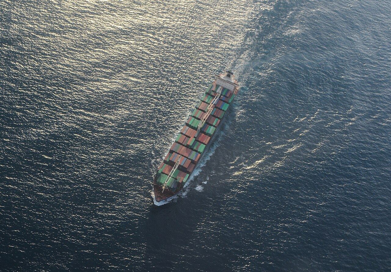 Container vessel under way at sea, seen from the air